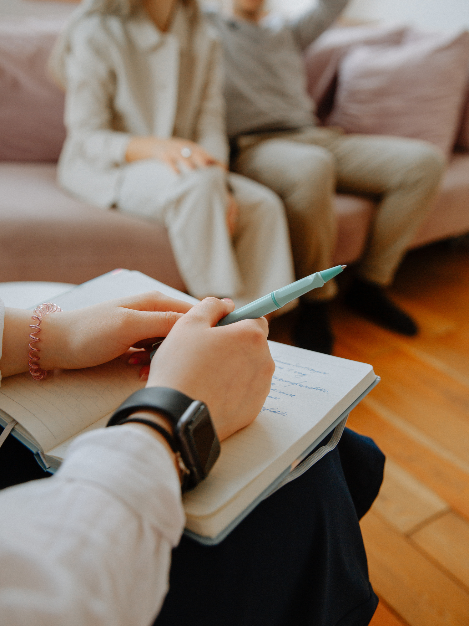 Behavioral health coach taking notes during a session